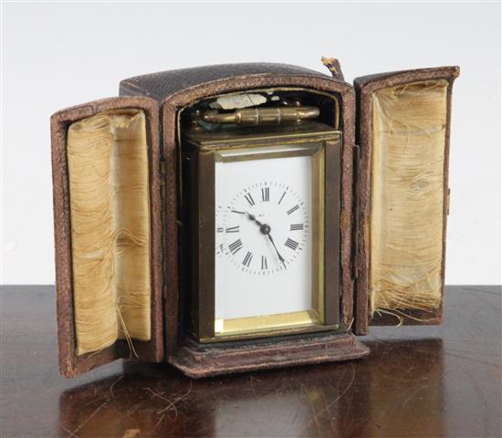 An early 20th century brass miniature carriage timepiece, 2.5in. in travelling case